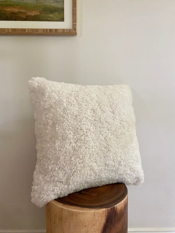 Side-view of ivory shearling sheepskin pillow