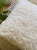 Top-view of ivory shearling sheepskin pillow