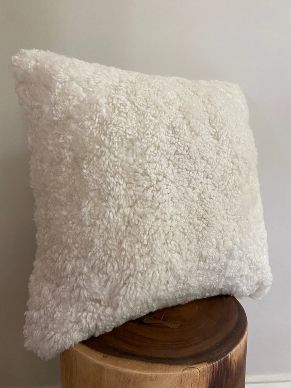 Side-view of ivory shearling sheepskin pillow