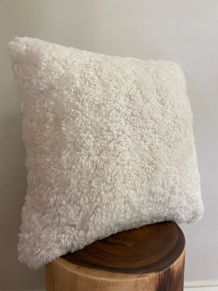 Side-view of ivory shearling sheepskin pillow