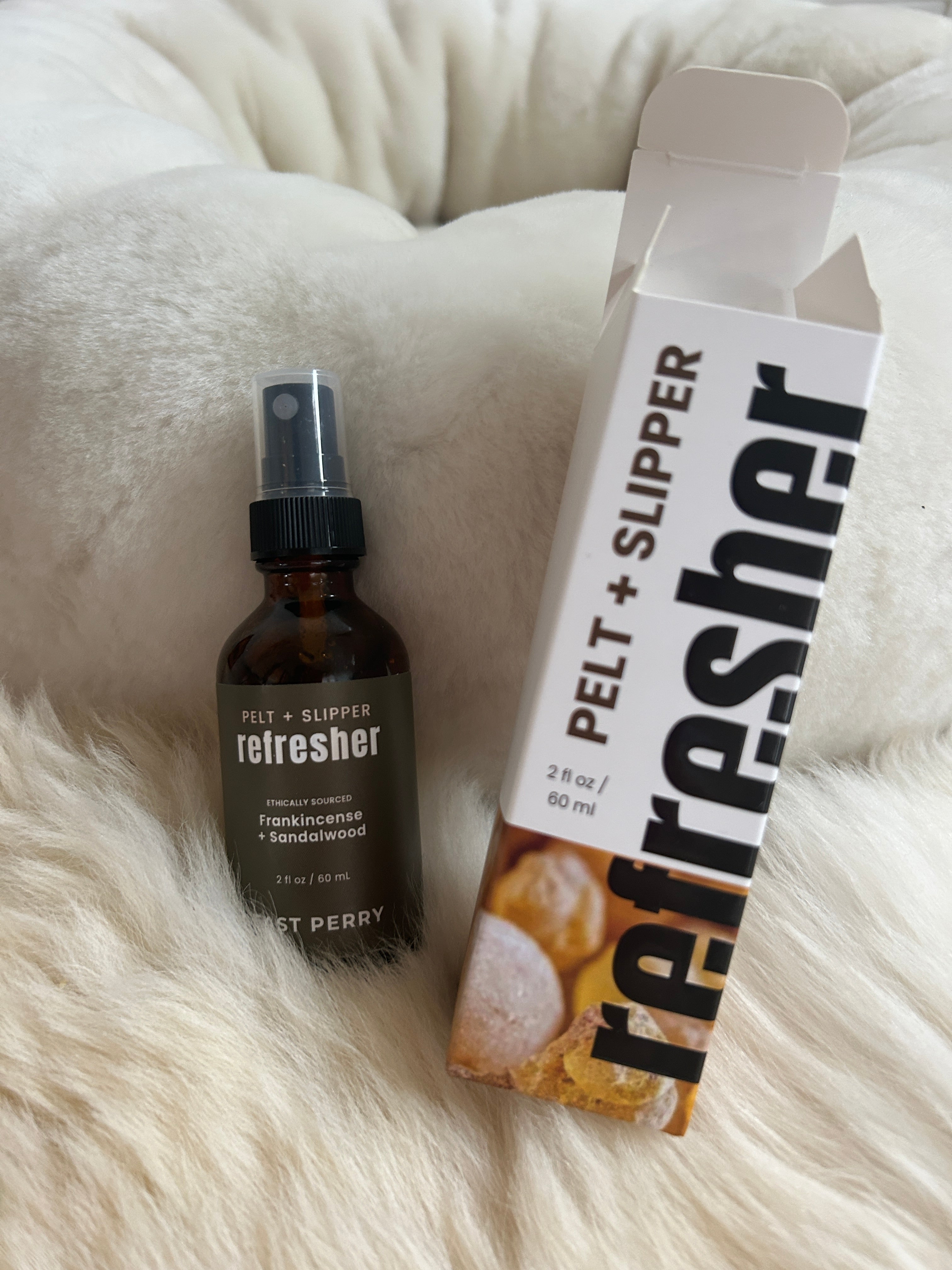 An East Perry Pelt + Slipper Refresher Spray and a box of slippers.