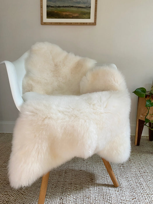 Bright ivory nursery sheepskin on a chair