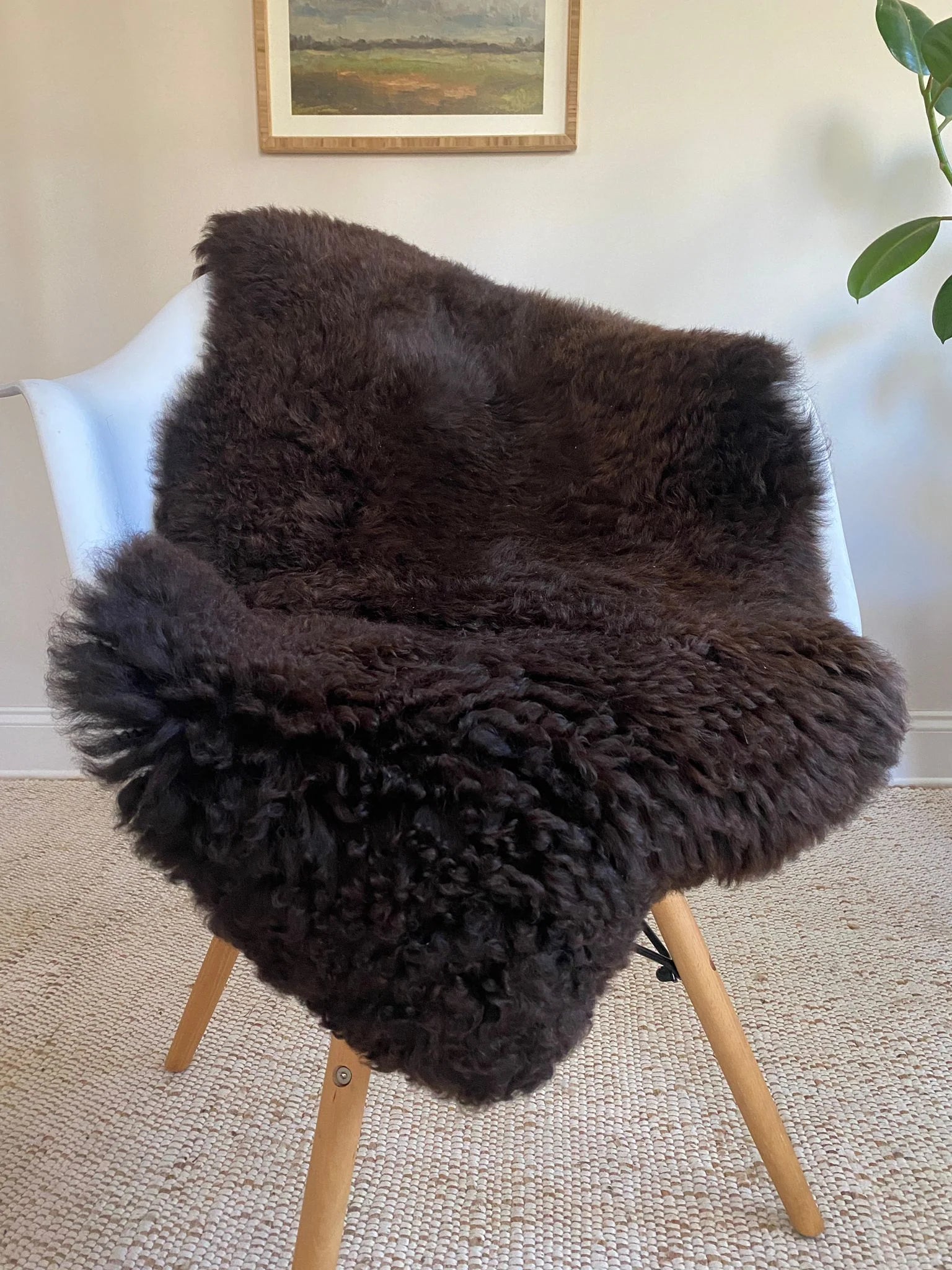 Dark Brown sheepskin rug draped over a chair 