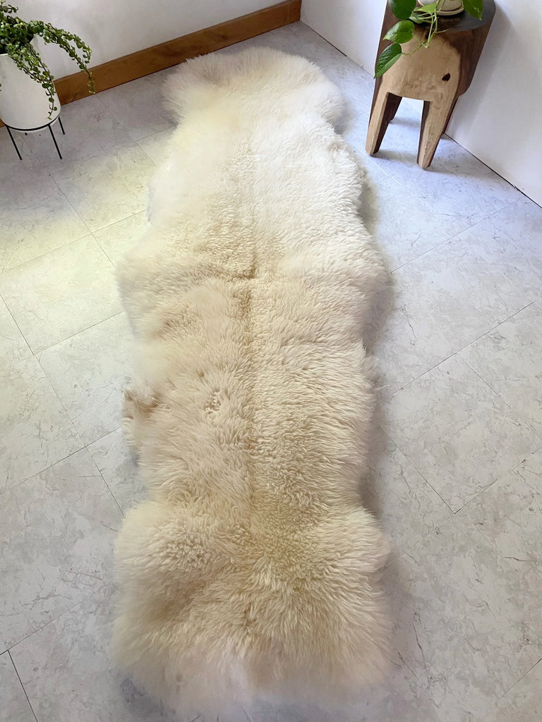 Double sheepskin in white on a light gray floor 