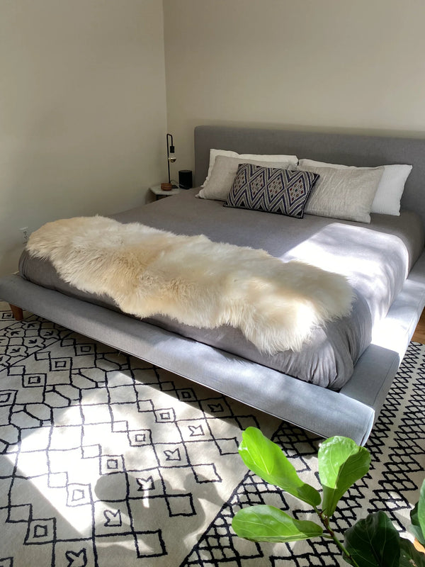 Bedroom with double sheepskin in white