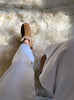 Extra roomy genuine sheepskin slipper on a fluffy white rug