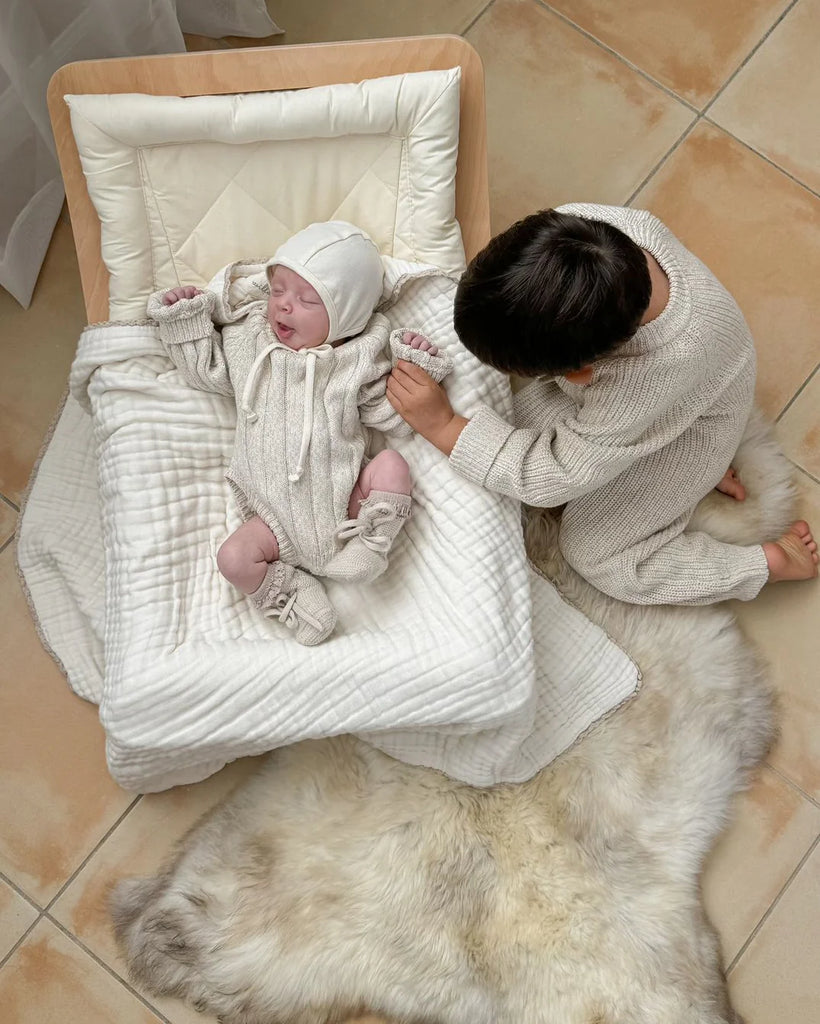 Newborn baby in a white outfit family bundles