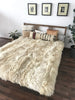 Bed with ivory plush sheepskin blanket