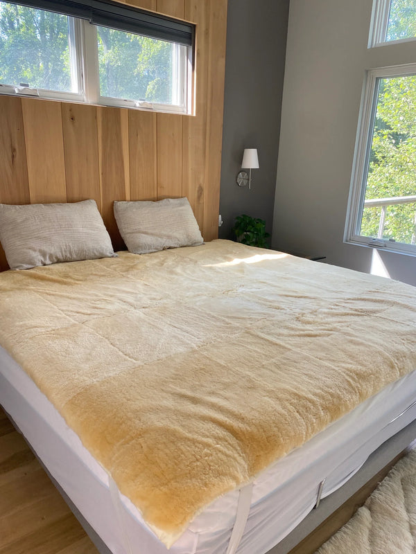 Bed with medical grade sheepskin mattress cover side view