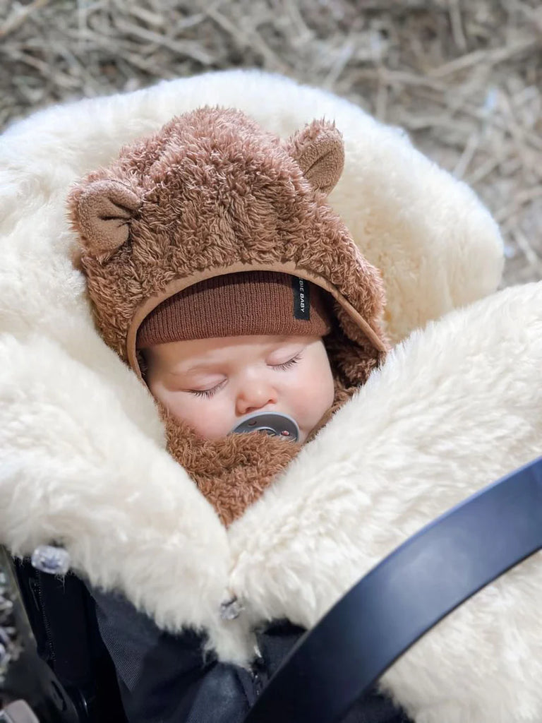 Baby sleeping in a medical sheepskin baby toddler sleeping bag