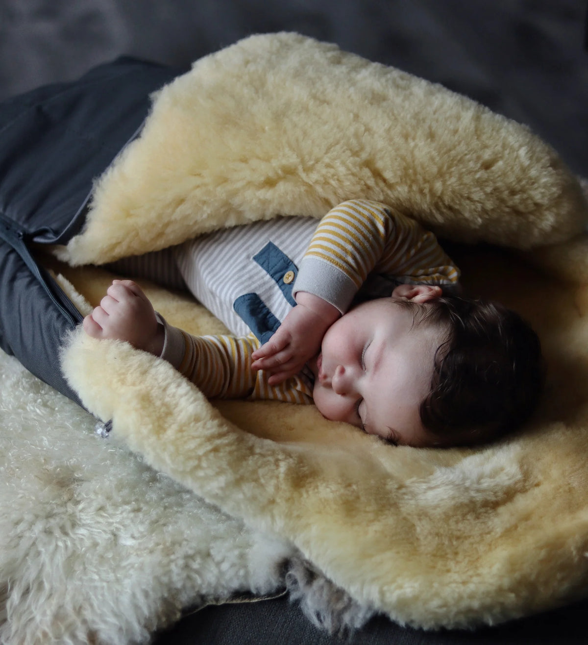 Baby sleeping in a medical sheepskin baby toddler sleeping bag