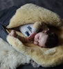 Baby sleeping in a medical sheepskin baby toddler sleeping bag