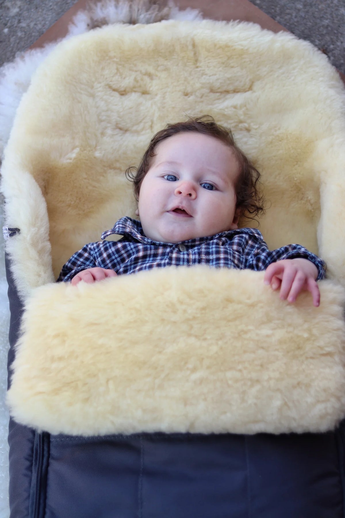 Baby lying on a medical sheepskin baby toddler sleeping bag
