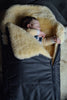 Baby sleeping in a medical sheepskin baby toddler sleeping bag