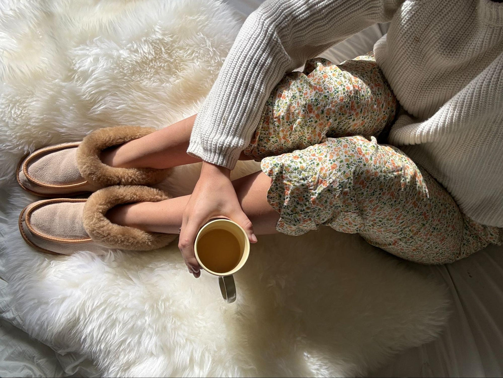 A mother resting on natural sheepskin