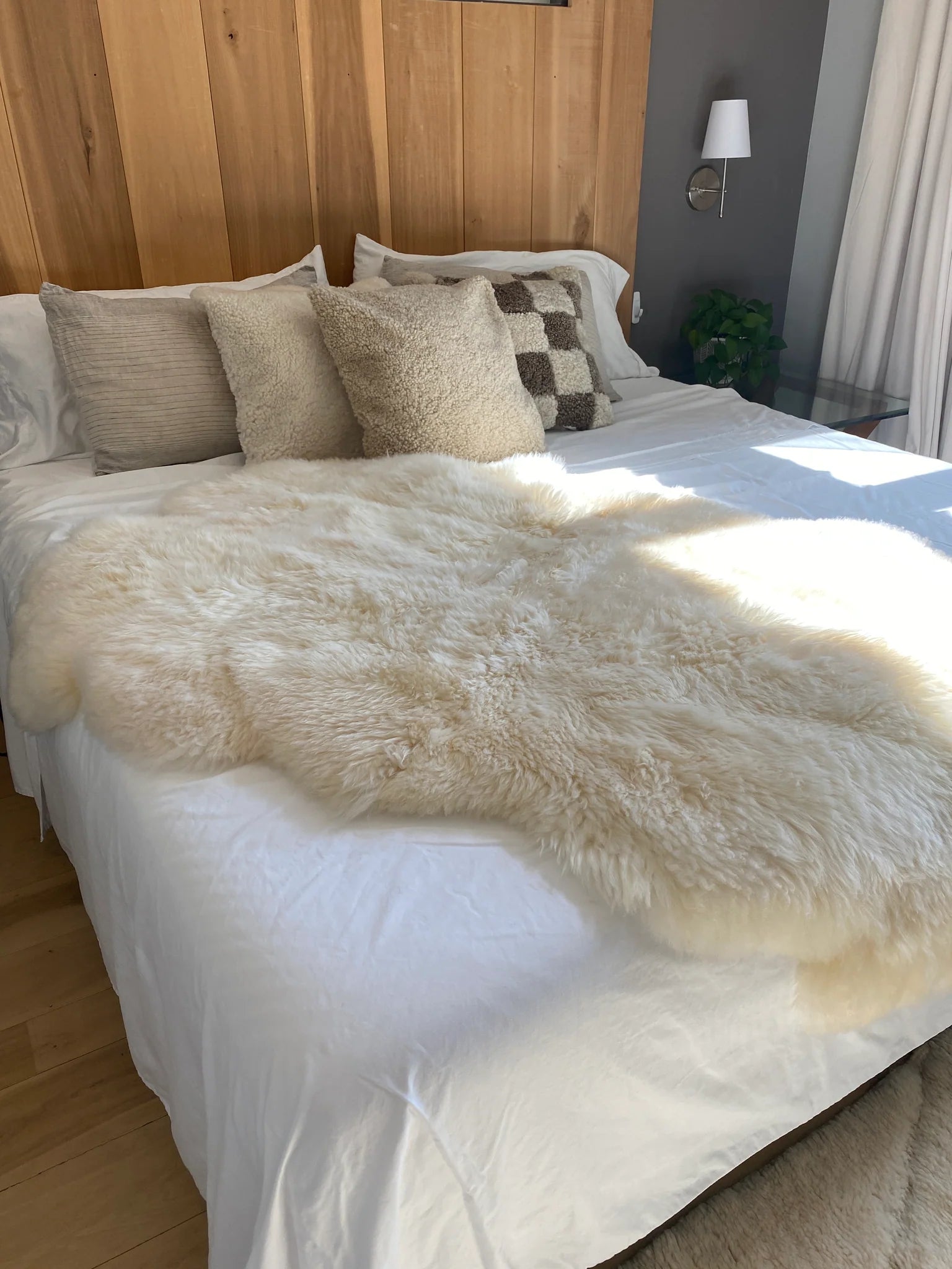 Bed with plush quad pelt ivory sheepskin
