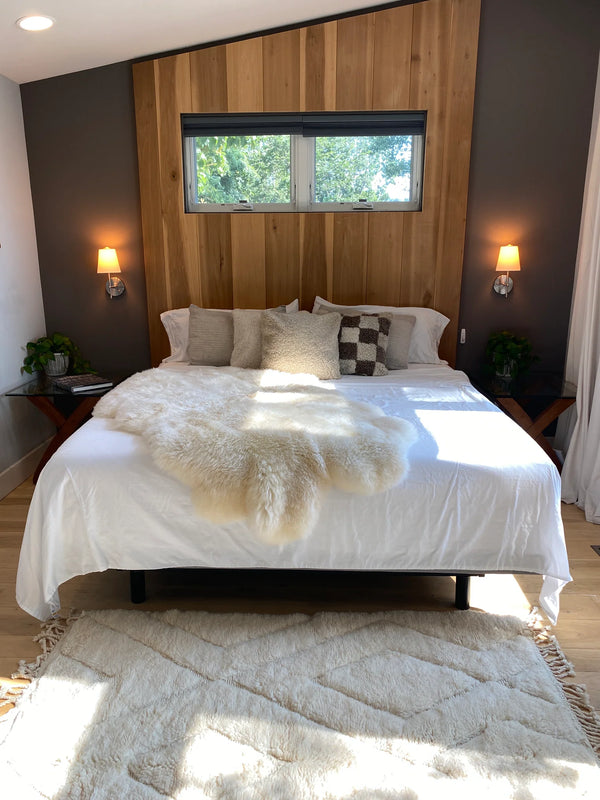 Bed with plush quad pelt ivory sheepskin 