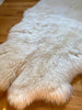 Side-view of plush quad pelt ivory sheepskin 
