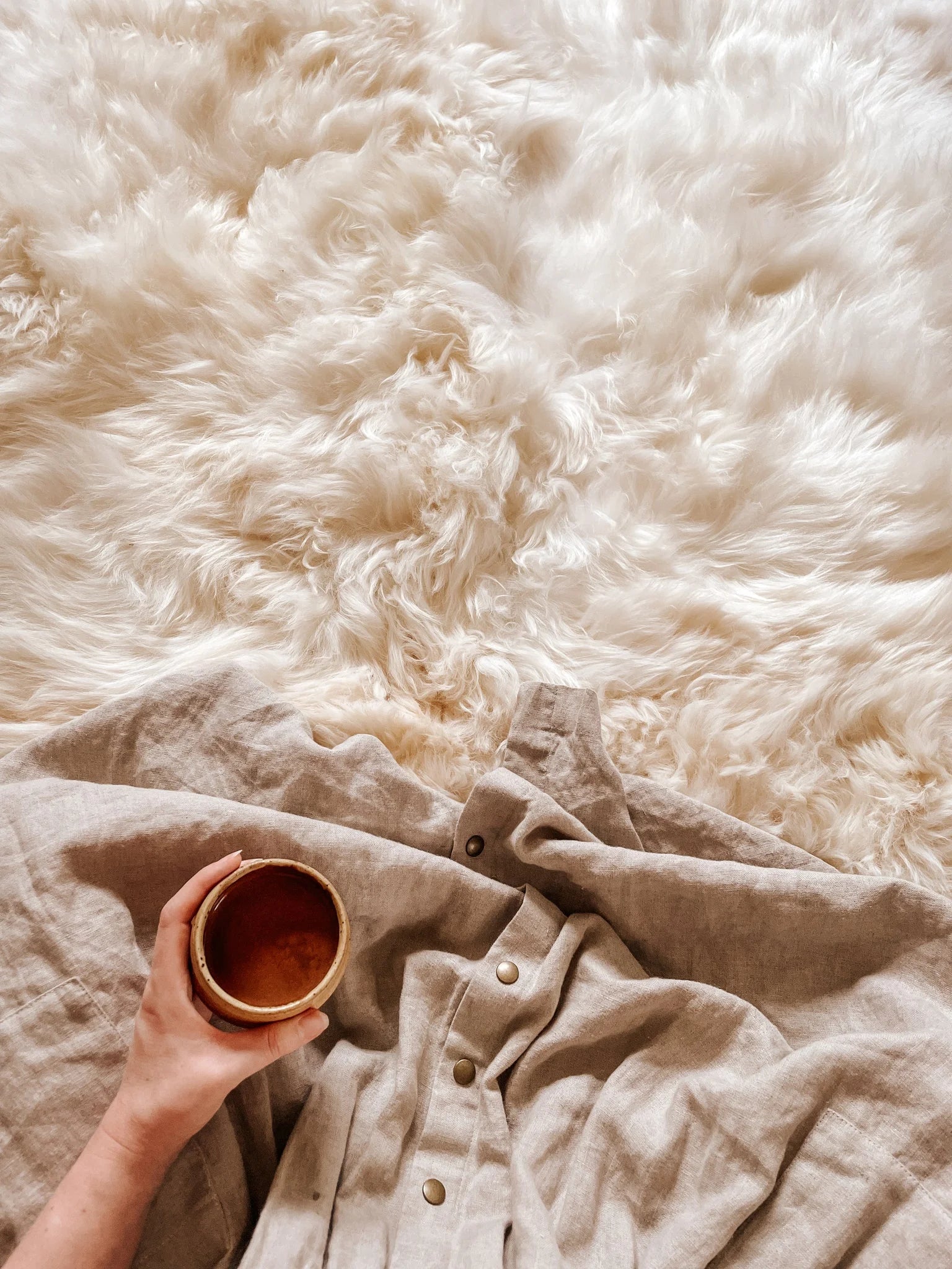 Close-up of soft plush texture of ivory sheepskin rug