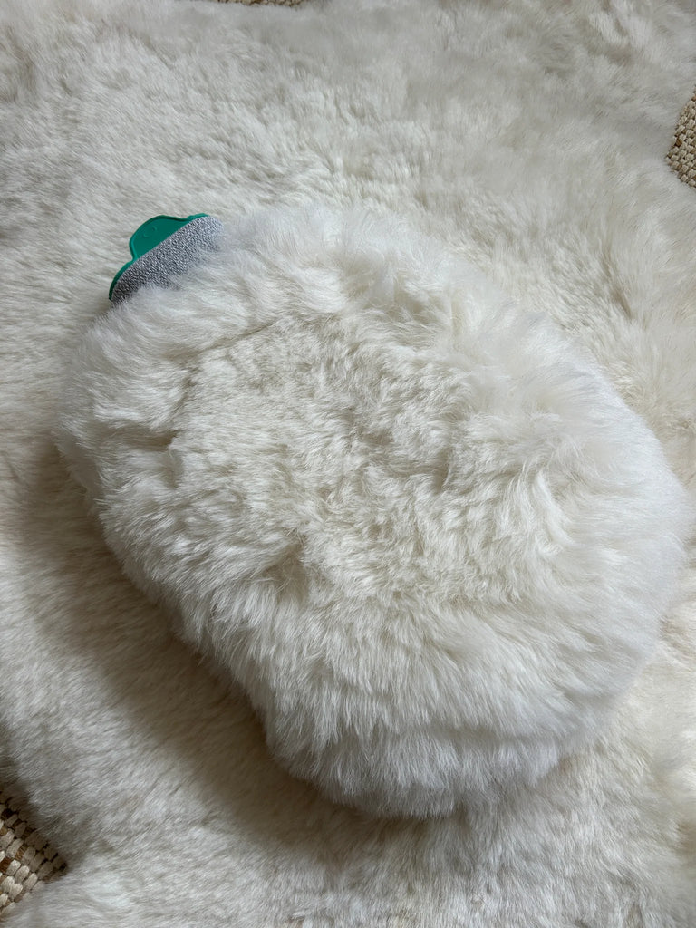 Close-up of sheepskin hot water bottle warmer