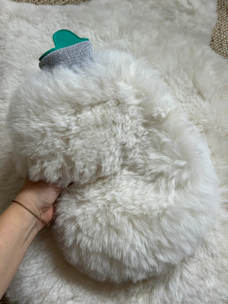 Close-up of sheepskin hot water bottle warmer