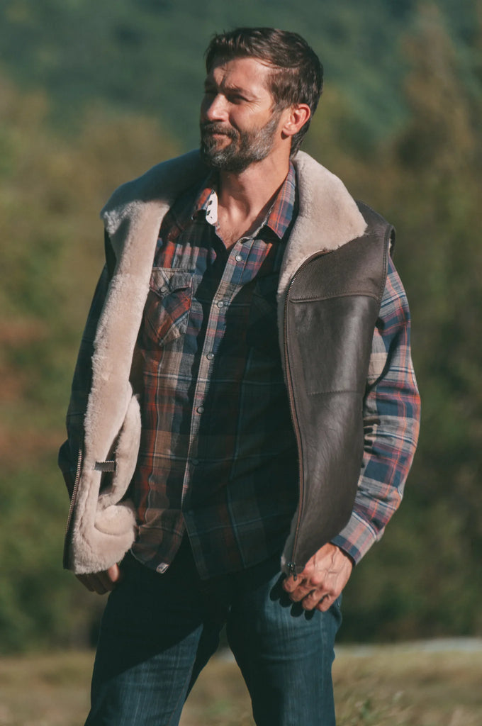 Man wearing a leather sheepskin mens vest outdoors