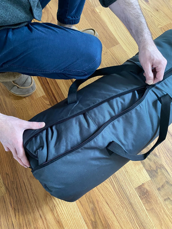 Person packing sheepskin sleeping bag