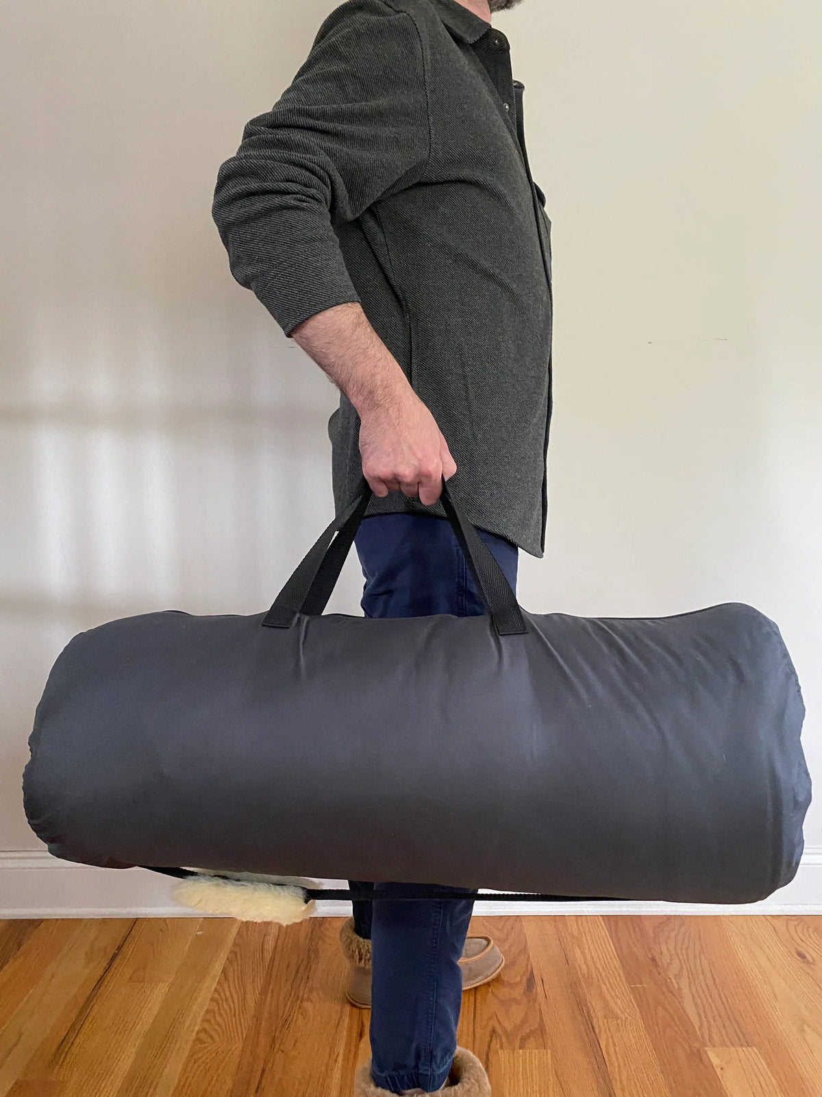 Person holding a sheepskin sleeping bag