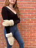 Person wearing the haven sheepskin mitten in cream