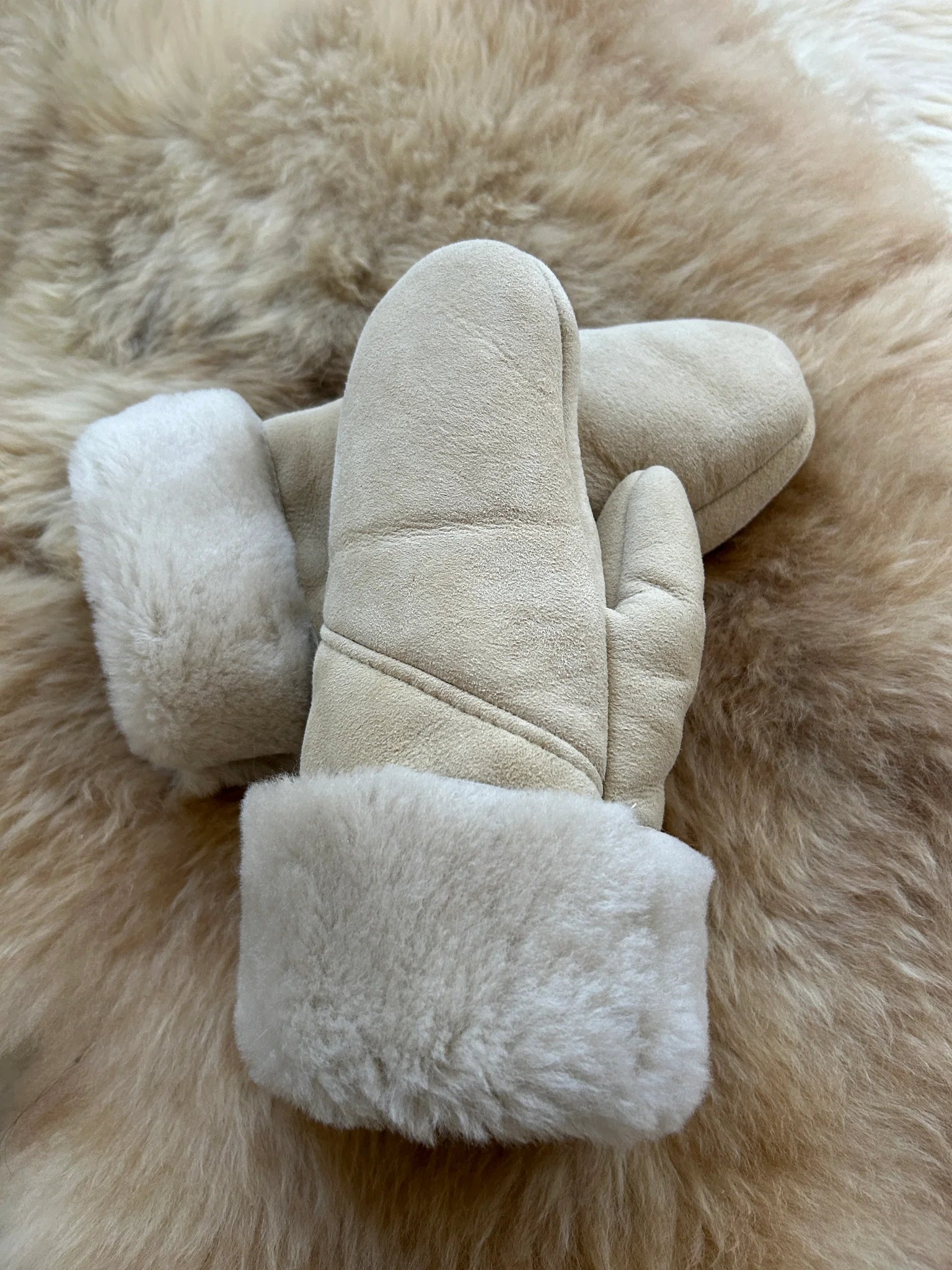Pair of the haven sheepskin mitten in cream