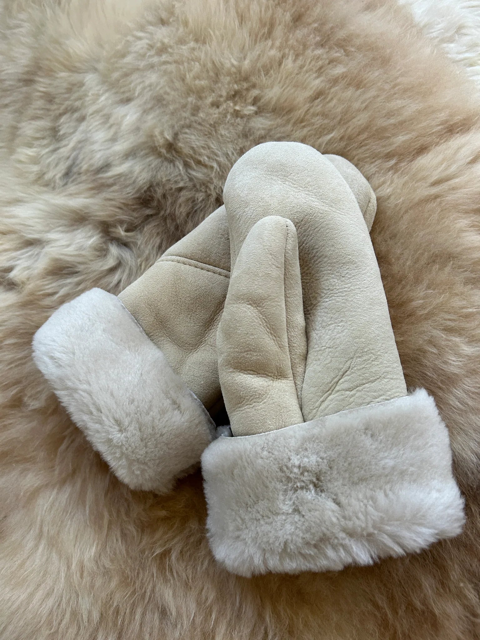 Pair of the haven sheepskin mitten in cream