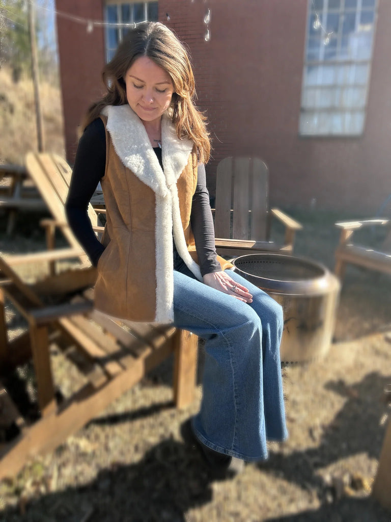 Woman sitting outdoors wearingthe maven vest
