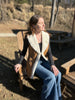 Woman sitting outdoors wearing the maven vest